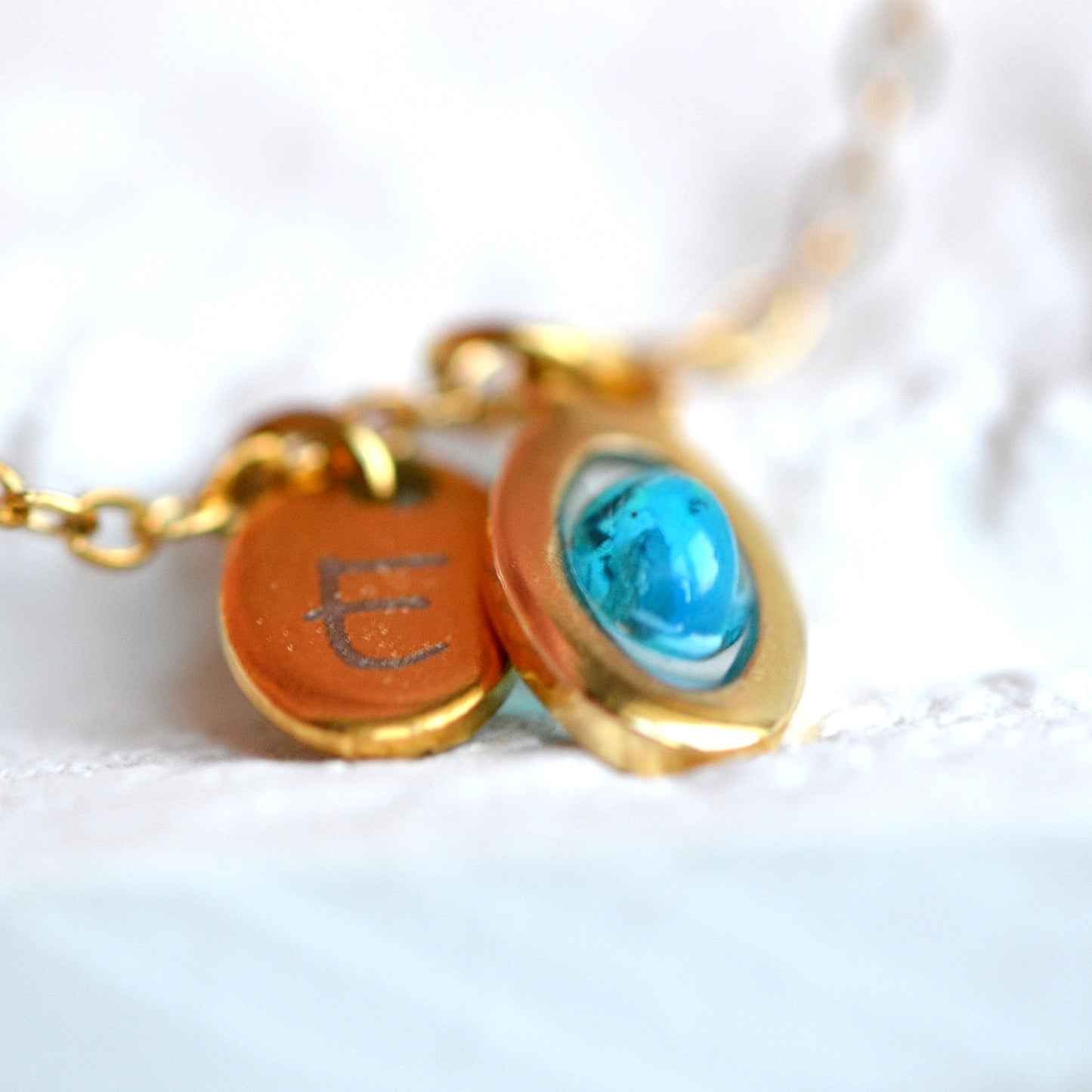 Necklace with opal and initial in gold setting