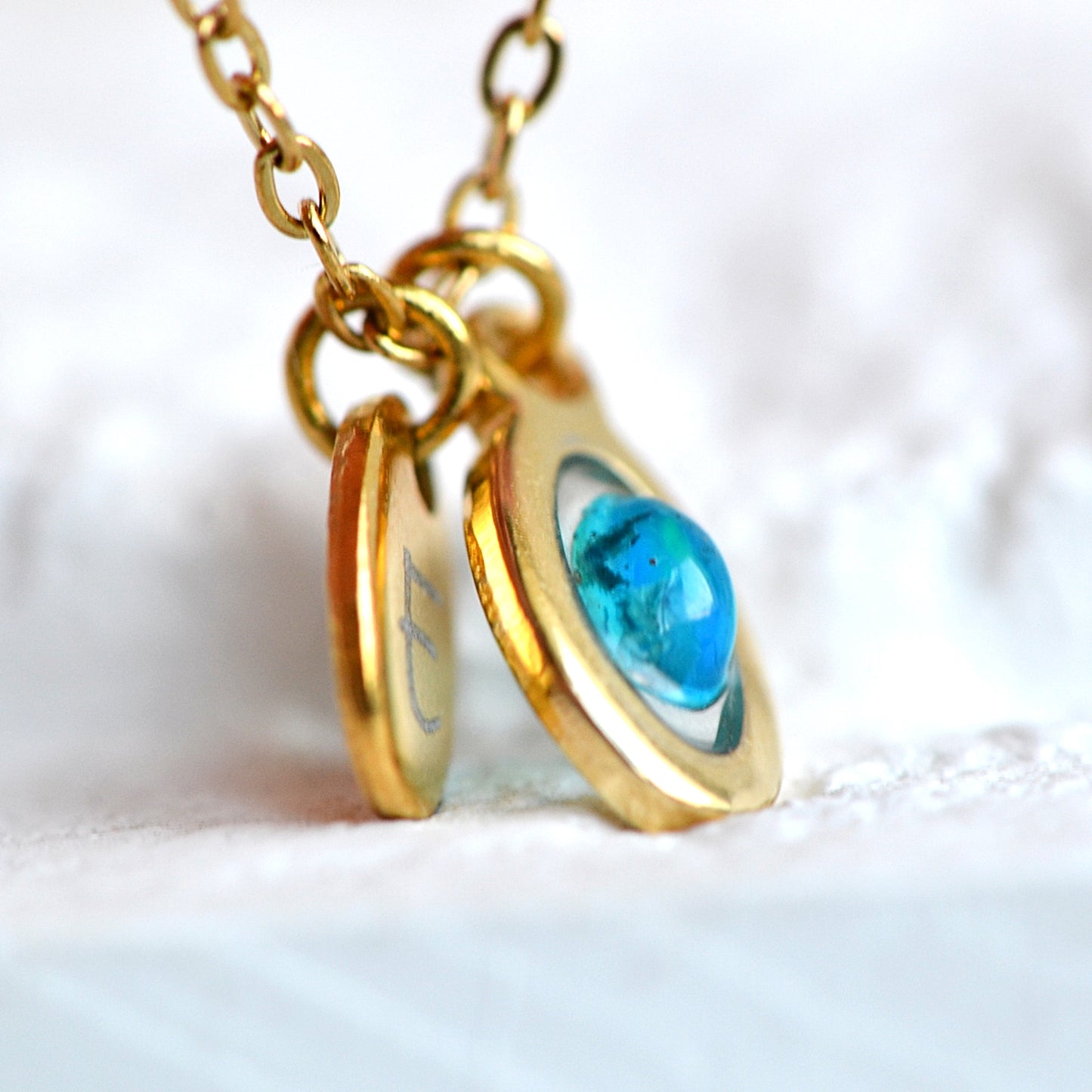 Necklace with opal and initial in gold setting