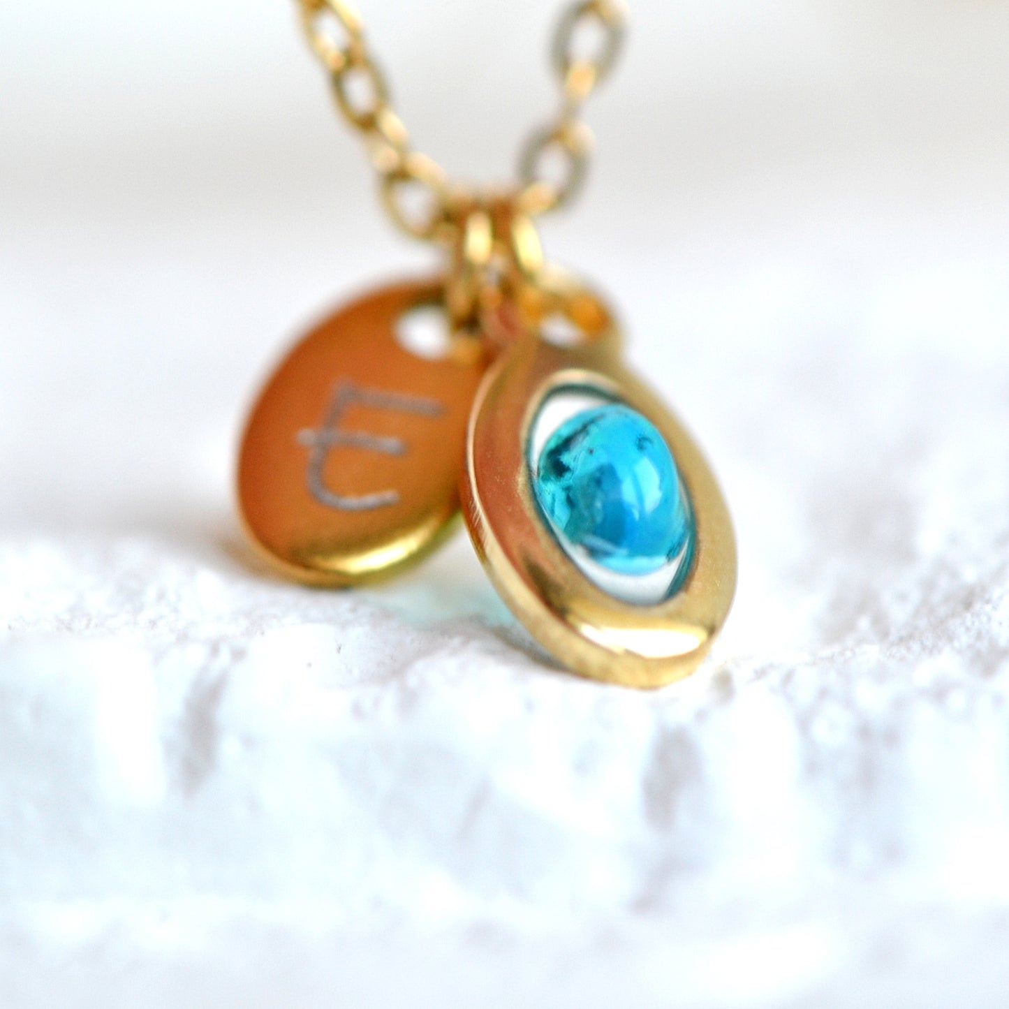 Necklace with opal and initial in gold setting