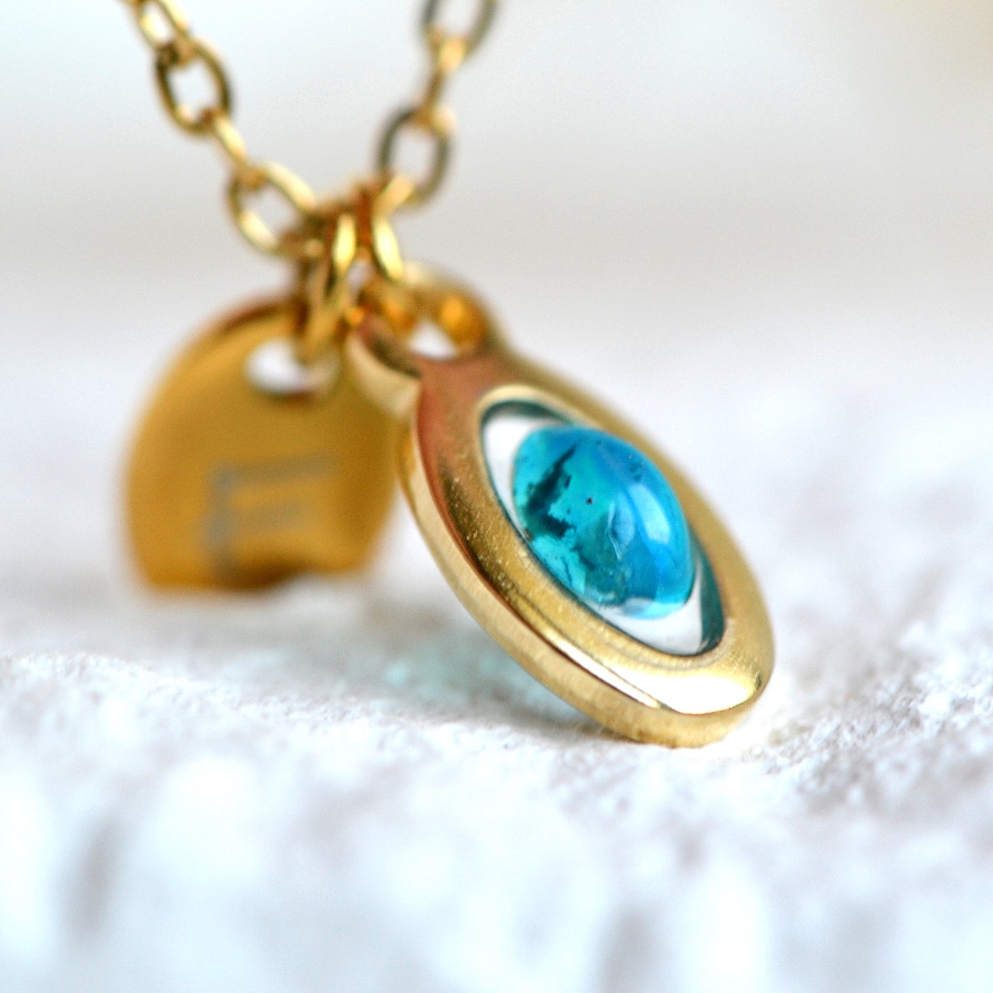 Necklace with opal and initial in gold setting